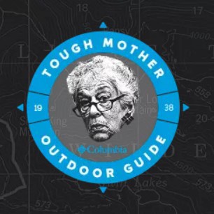 Columbia Sportswear Tough Mother Outdoor Guide logo. A black & white photo of founder Gert Boyle sits in the middle of a turquoise compass image on a black background with grey topographic lines.