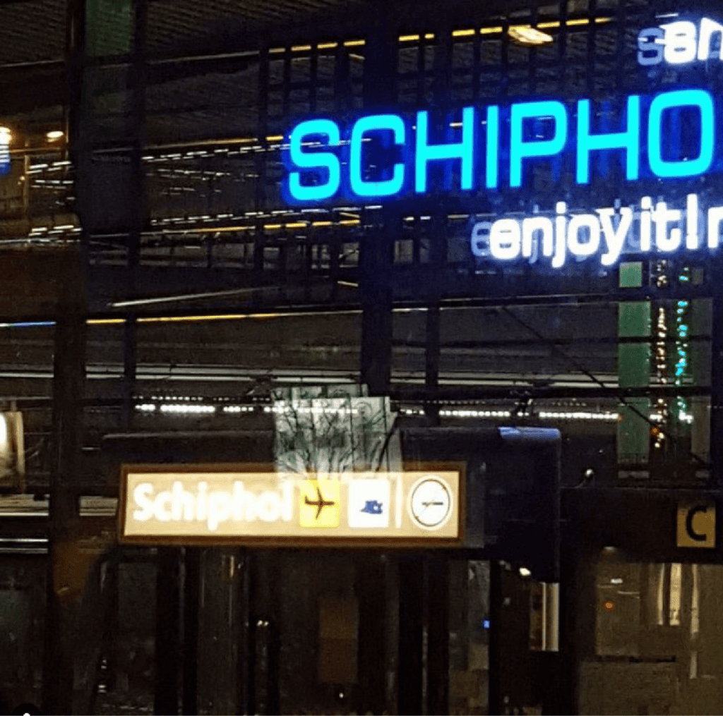 An abstract photo of neon signs at the Schipol airport at night